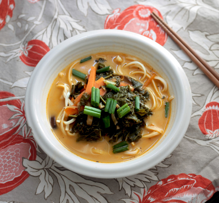 Healthy vegan rice noodle soup in creamy coconut kale broth