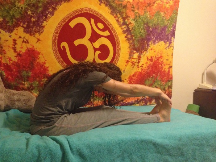 yoga in bed folding over