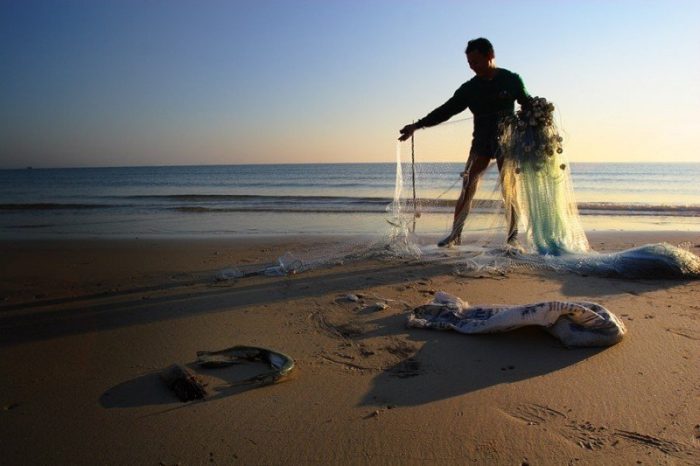 gathering nets from the beach