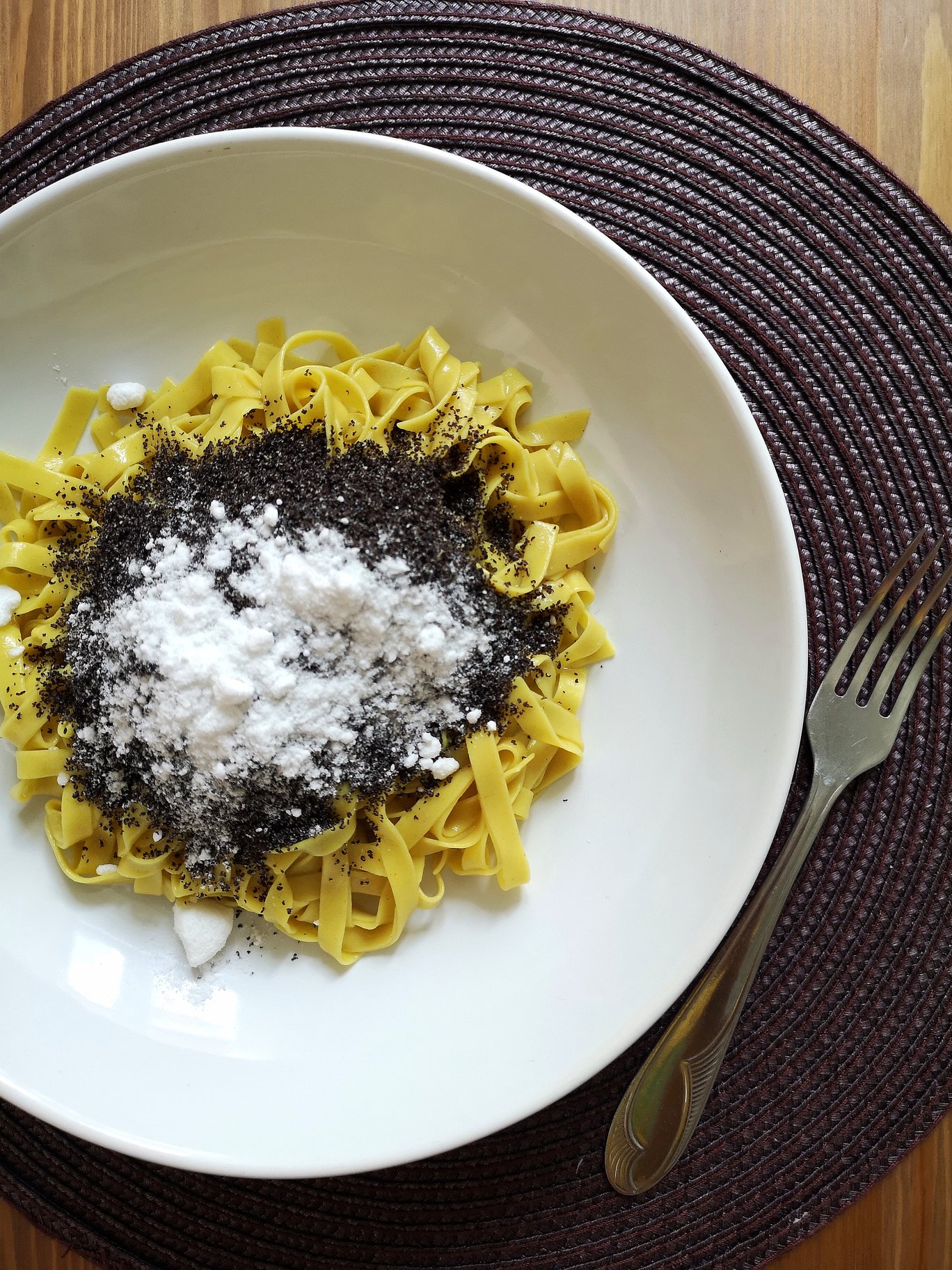 vegan hungarian poppy seed noodles in a white dish with a fork