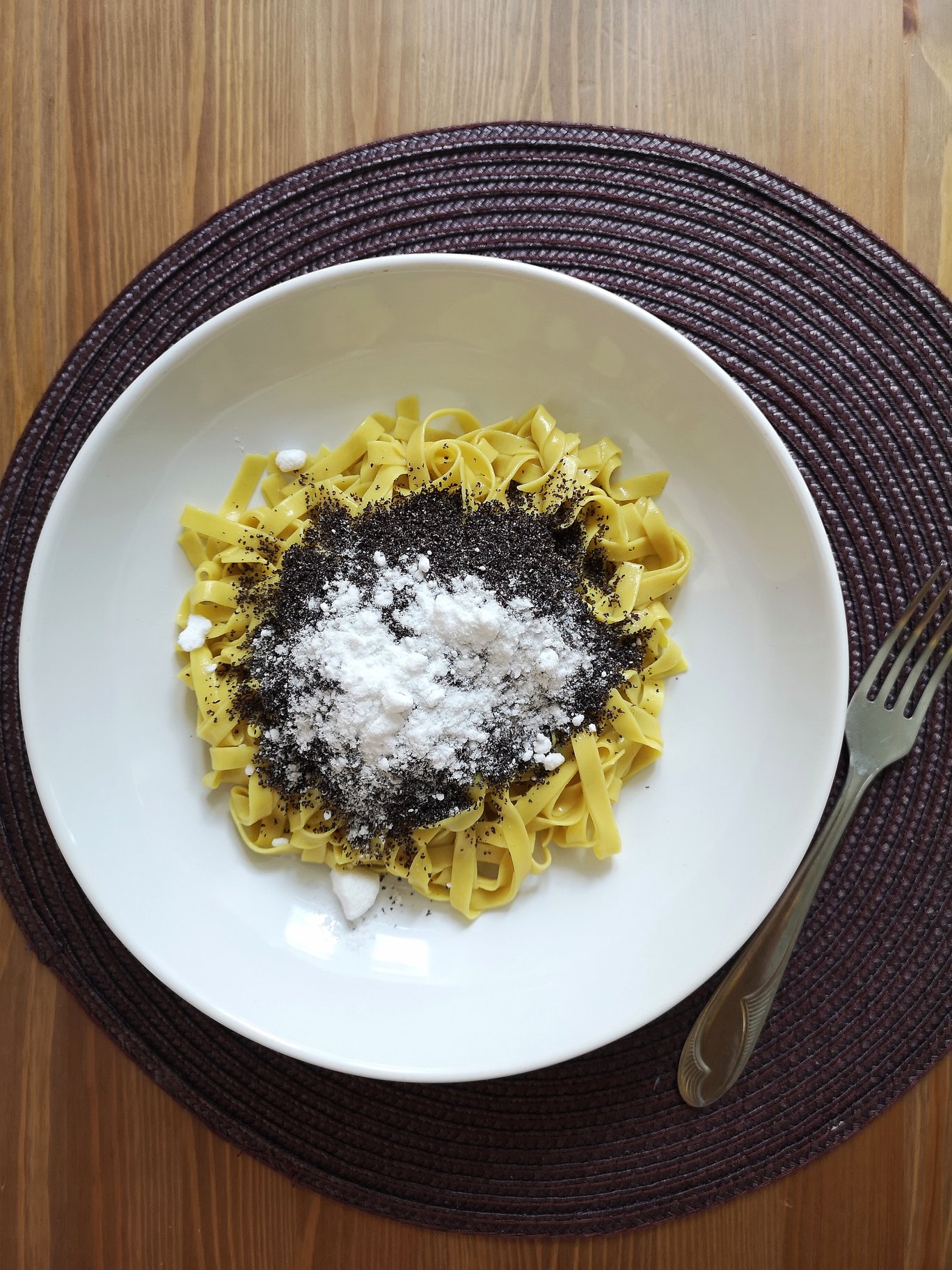 vegan hungarian poppy seed noodles in a white dish with a fork