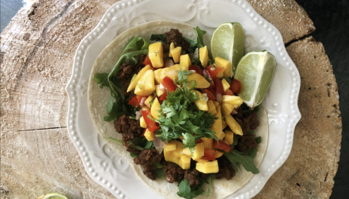 Jackfruit salsa on a white plate with brown and black background