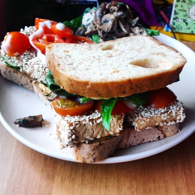 vegan grilled sesame tofu sandwich on a white plate