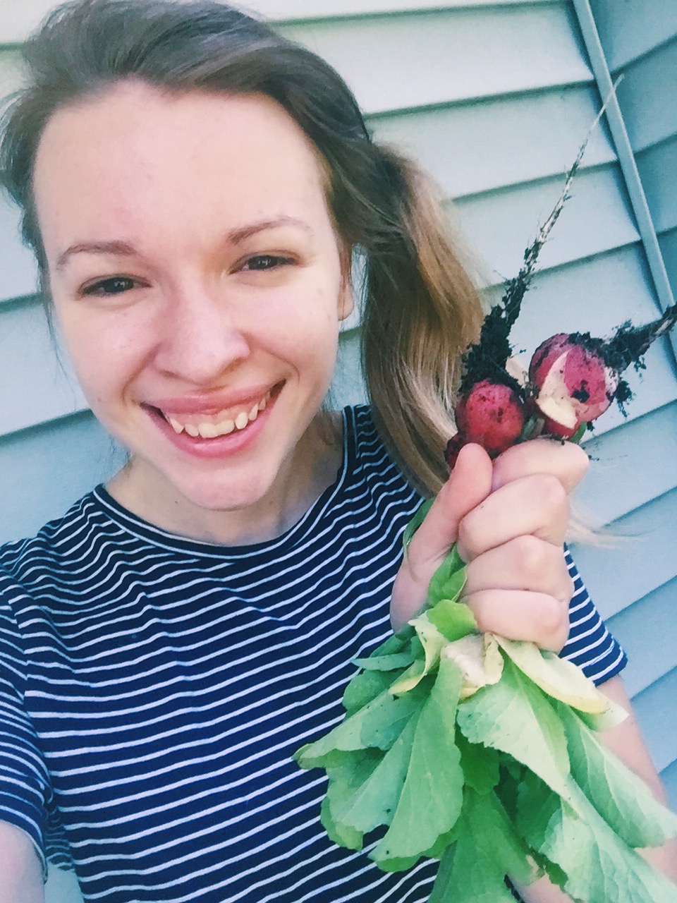 girl holding radishes