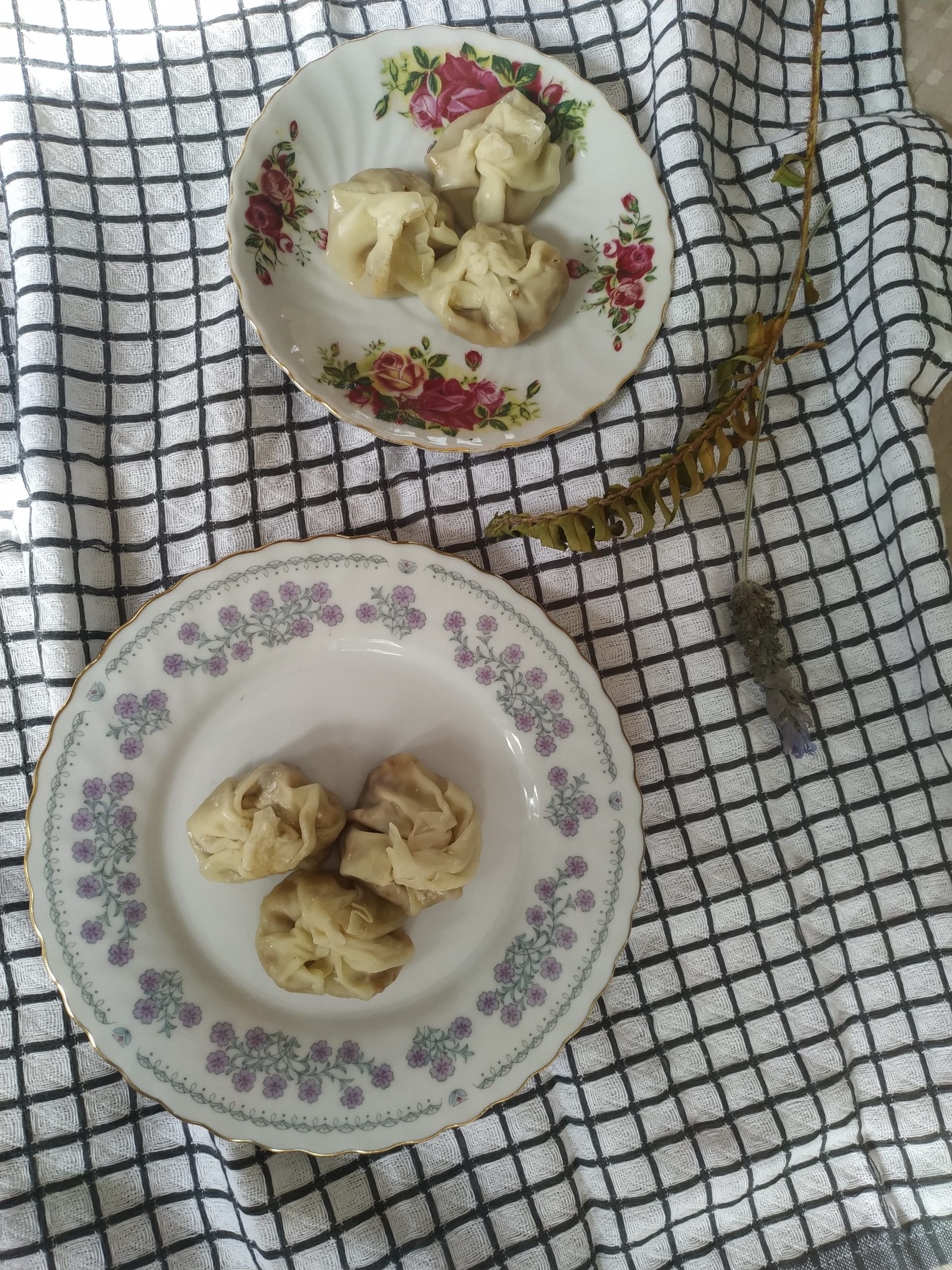 vegan wontons on decorative plates on a tablecloth