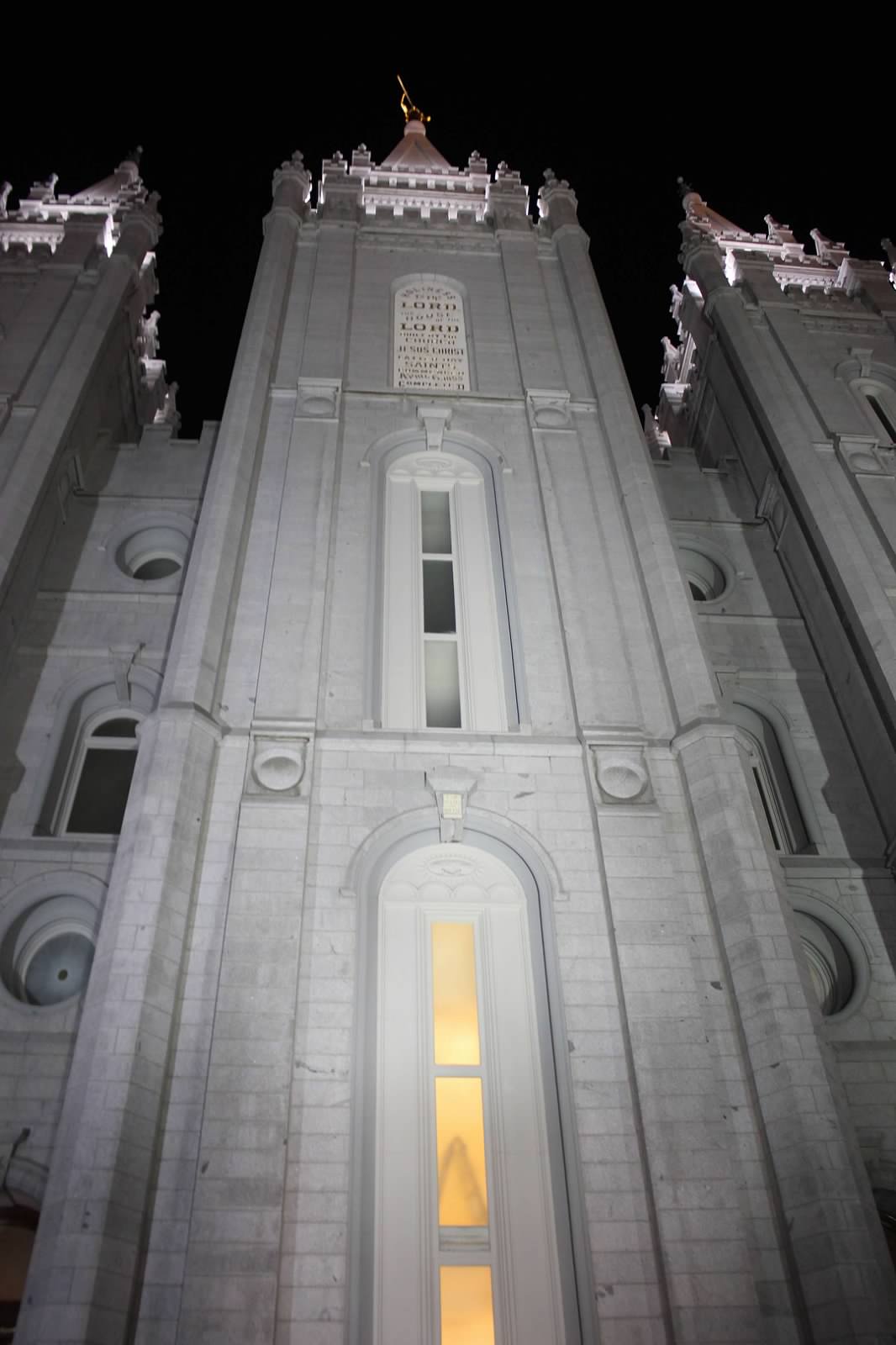 the façade of the Salt Lake City Mormon temple at night.