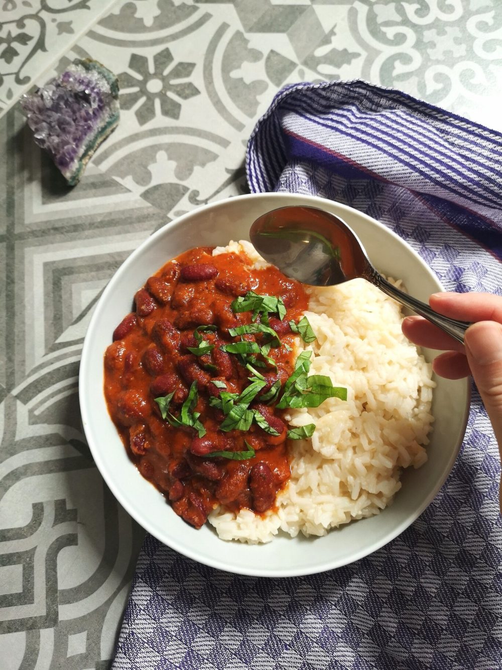 dominican beans and rice in a white bowl with a spoon