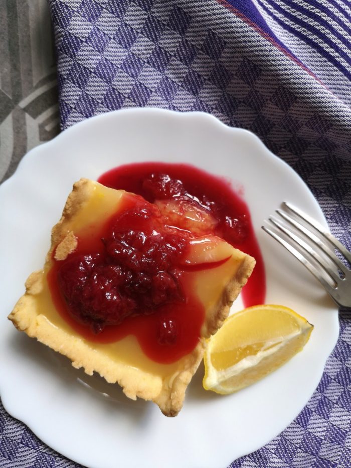 lemon pudding pie on a white plate with a fork