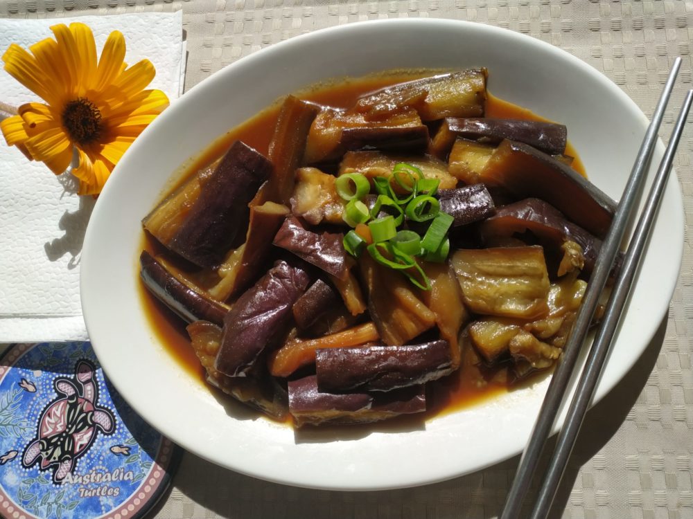 stir fried eggplant with sweet and spicy garlic sauce on a white plate