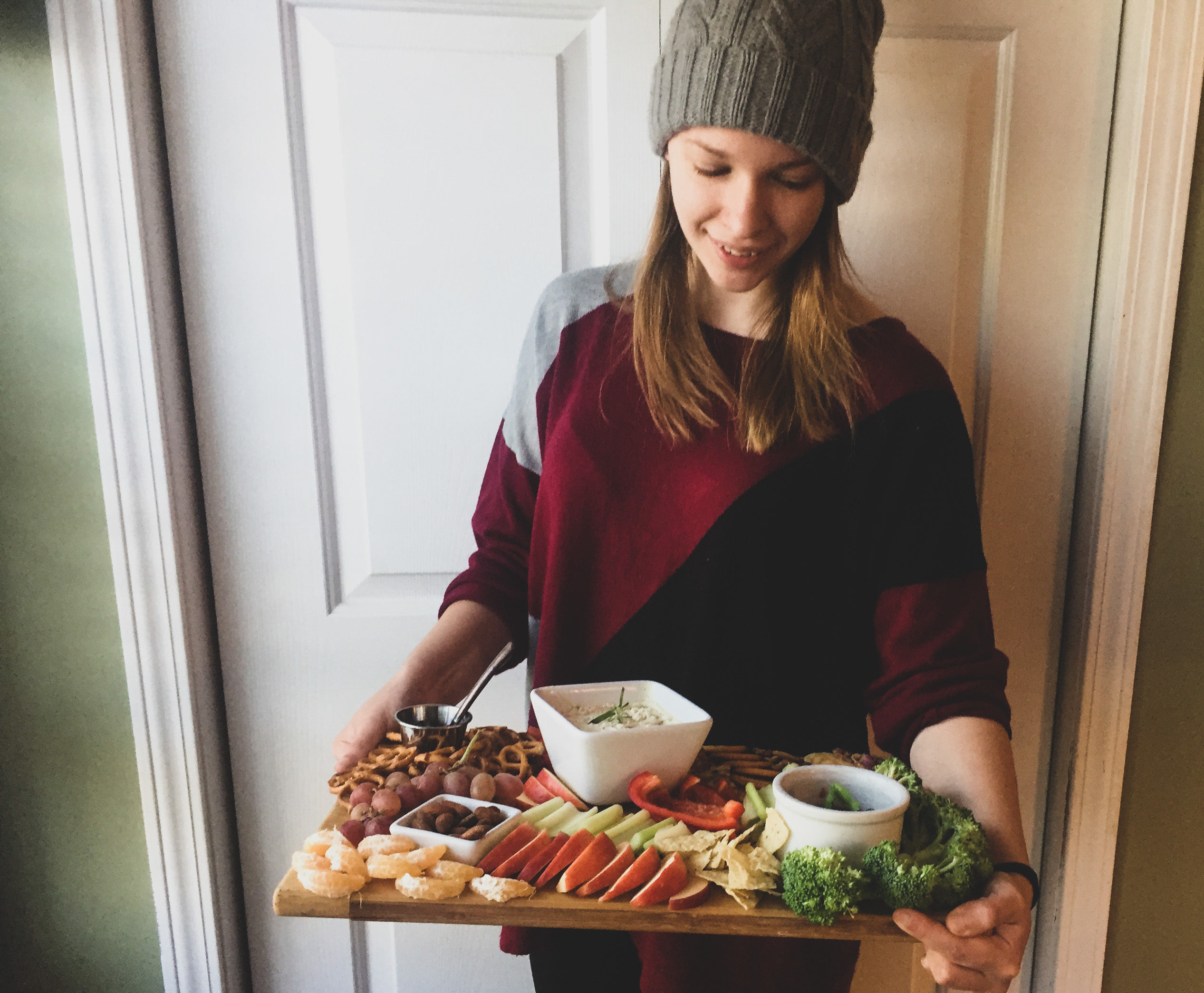 woman holding vegan charcuterie board