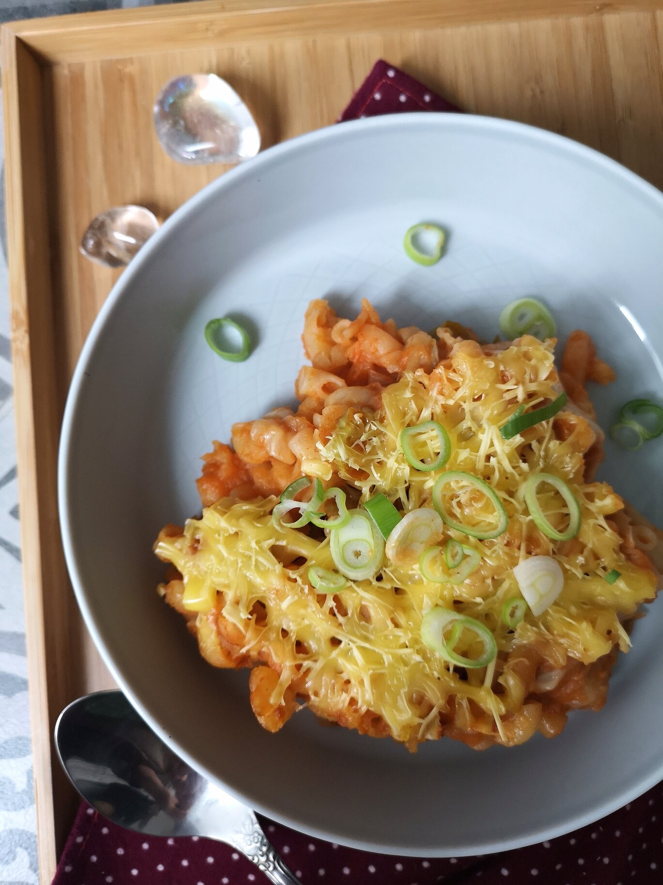 vegna kimchi mac n cheese on a white plate with a spoon