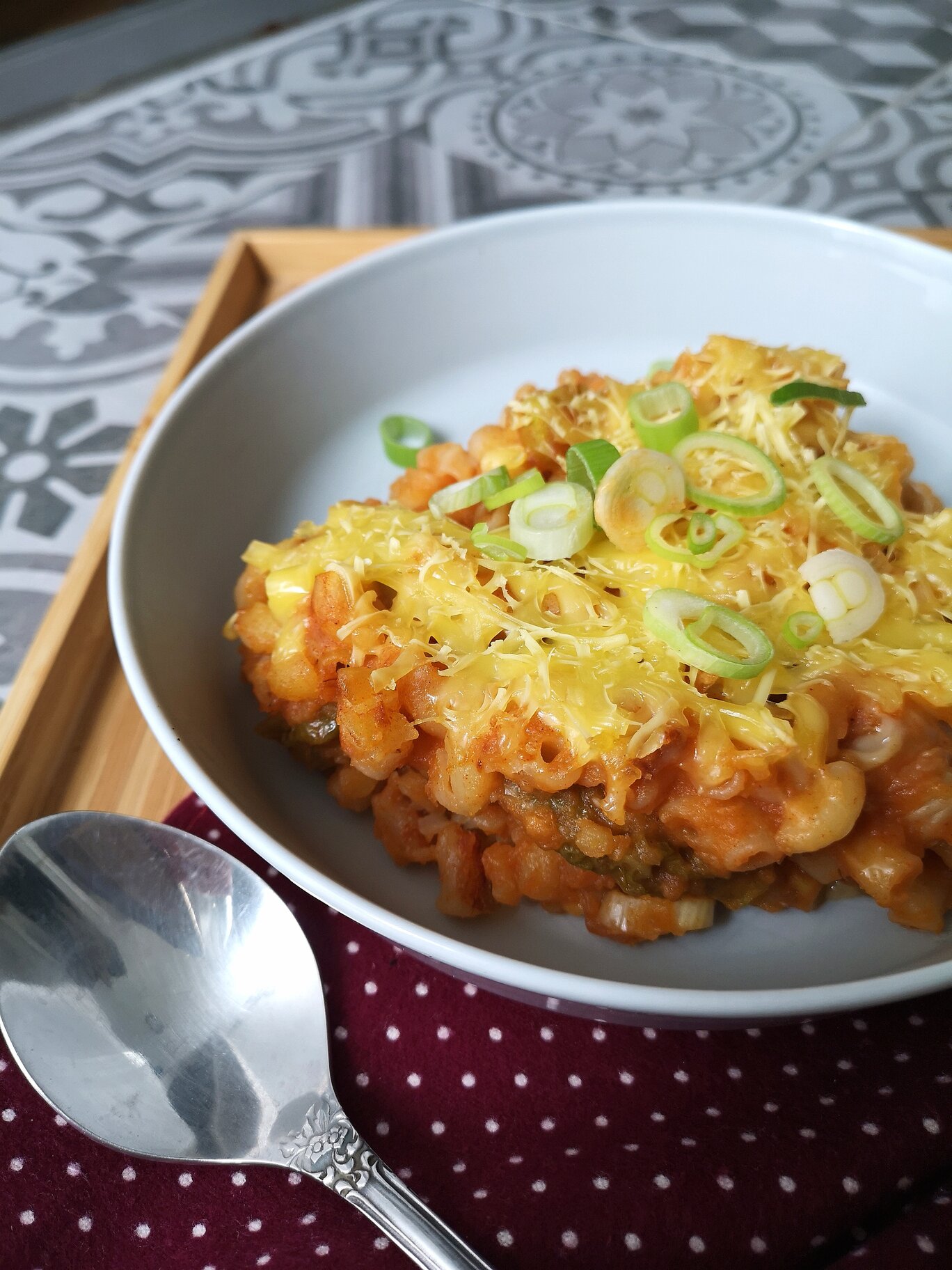 vegna kimchi mac n cheese on a white plate with a spoon