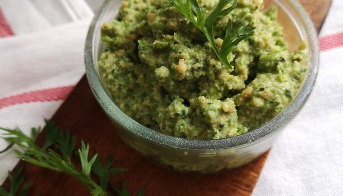 carrot top pesto in a clear dish on a cutting board