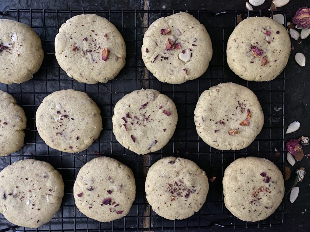 vegan cardamom rosewater shortbread cookies against a dark background