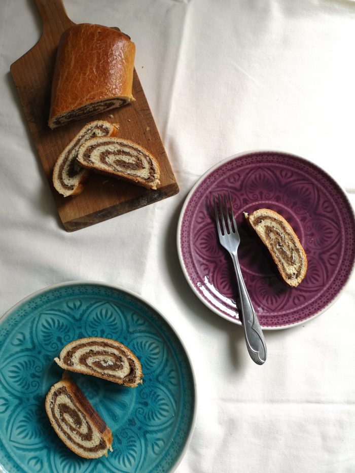 vegan bejgli; hungarian walnut roll on plates