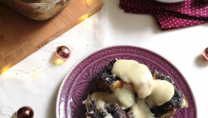 vegan hungarian poppy seed bread pudding on a plate with white background