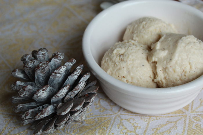 vegan eggnot ice cream in a white dish with pine cones