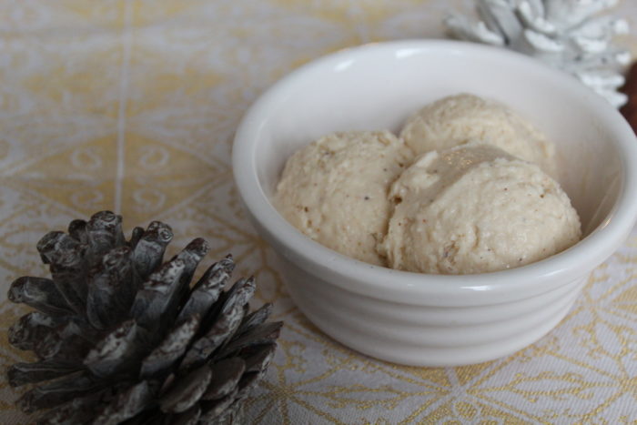 vegan eggnot ice cream in a white dish with pine cones