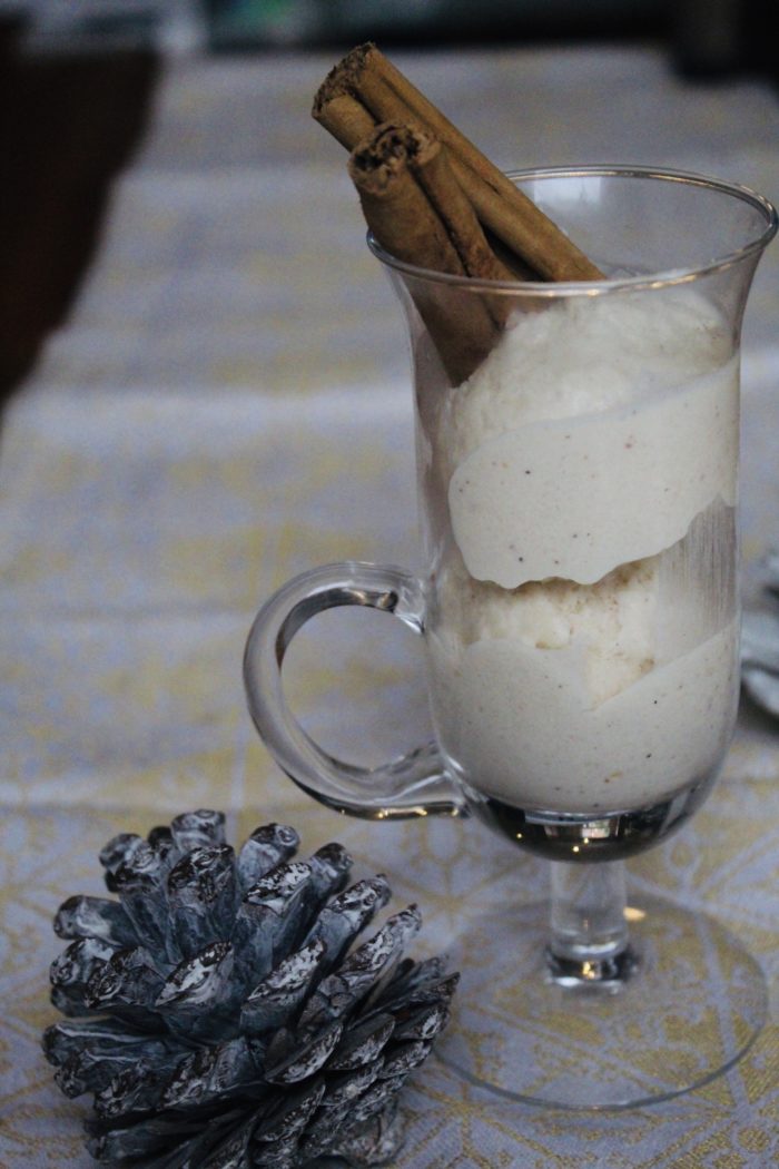 vegan eggnot ice cream in a clear glass with a pinecone