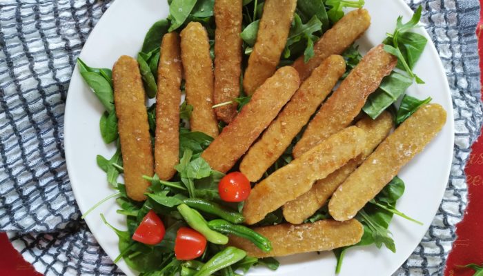 crispy tempeh and salad on a white plate