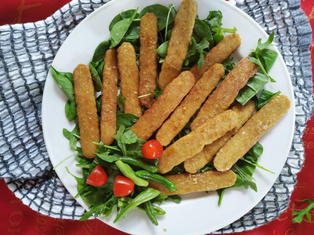 crispy tempeh and salad on a white plate