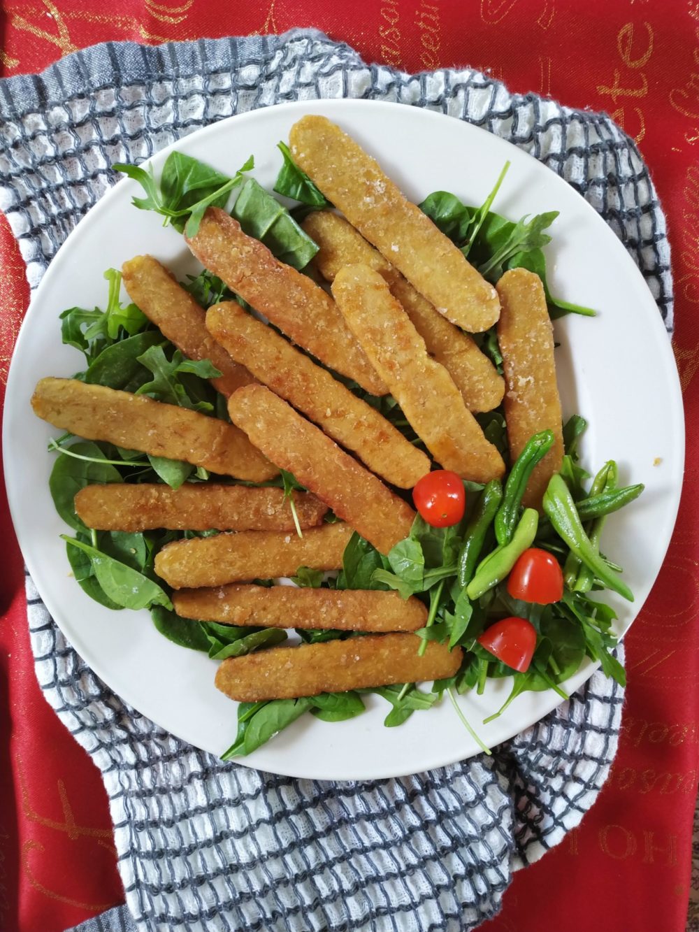 crispy tempeh and salad on a white plate