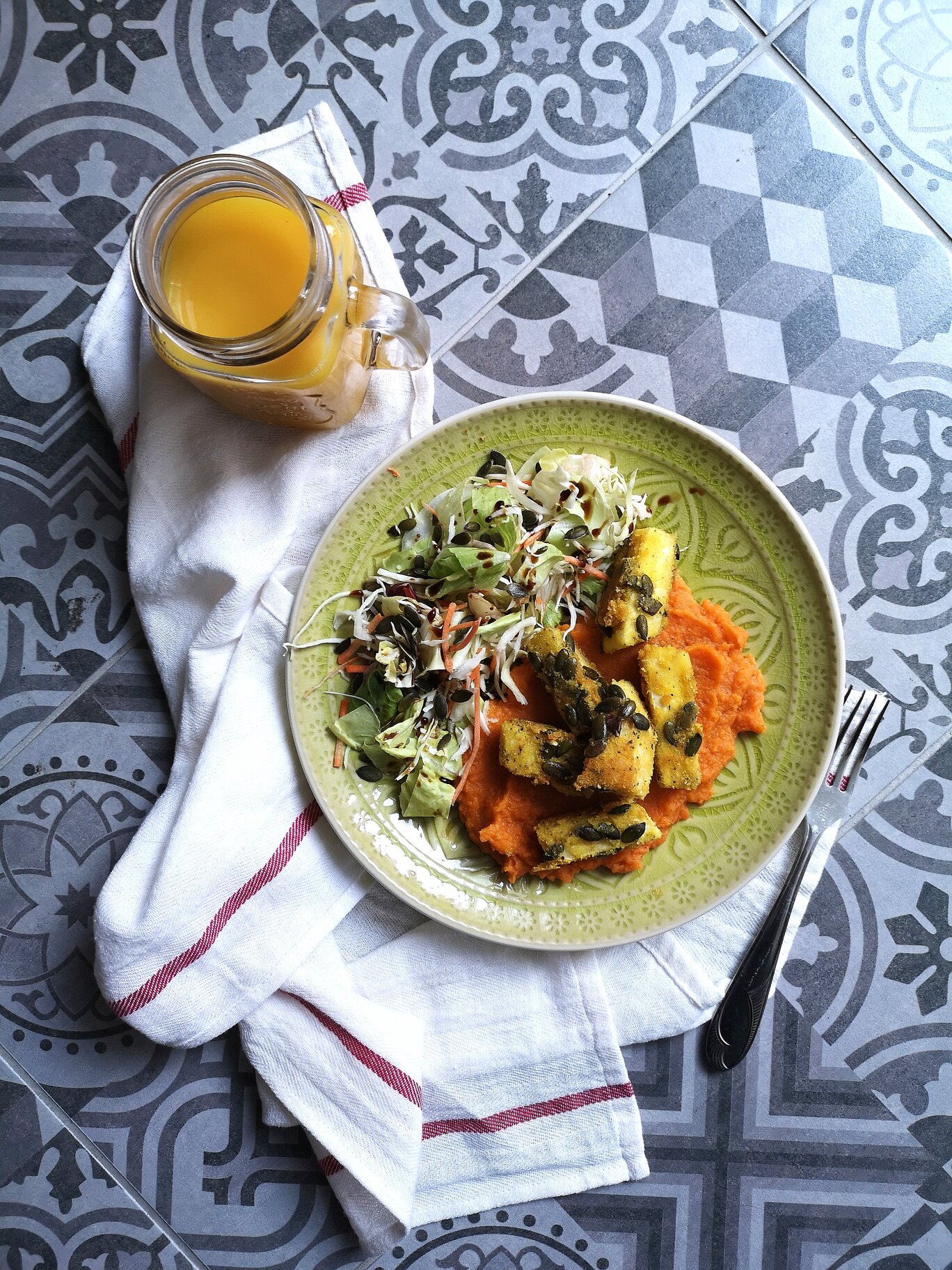 vegan deep fried celeriac with sweet potato puree on a green plate