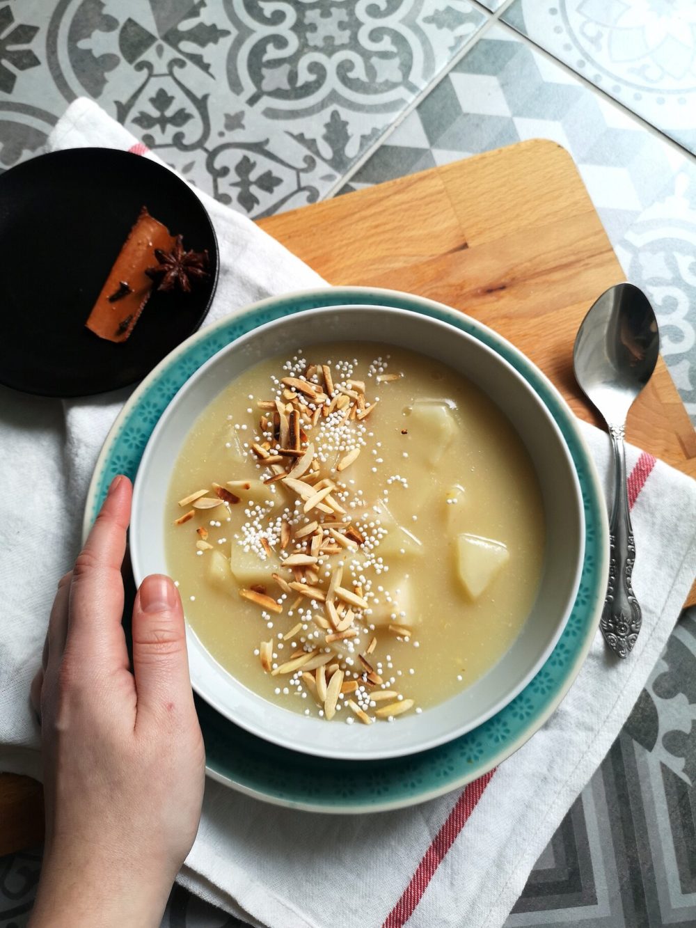 pear porridge in a bowl next to a spoon