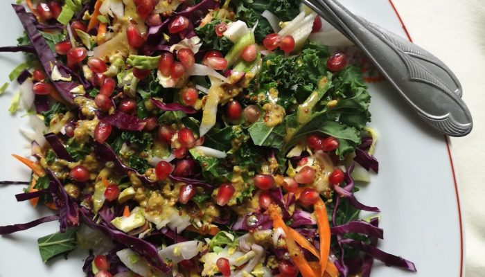 brussels sprout slaw on a white plate with a fork