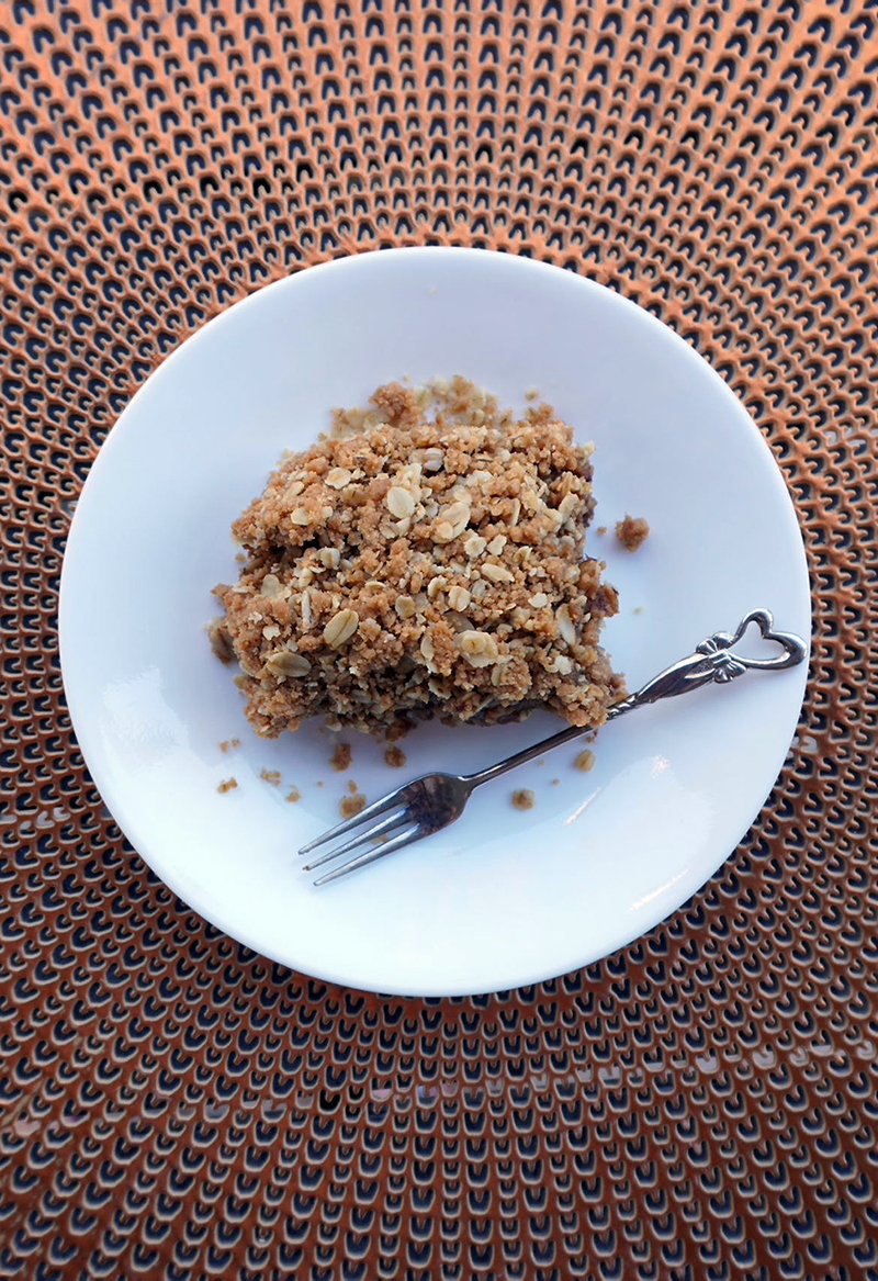 vegan date bar on a white plate with a fork