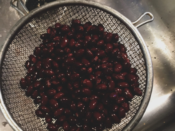 rinsing black beans in sink