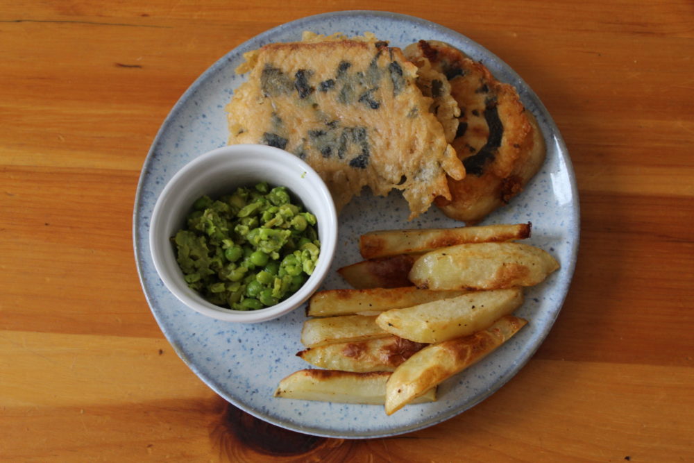 english tofish and chips with mushy peas on a plate