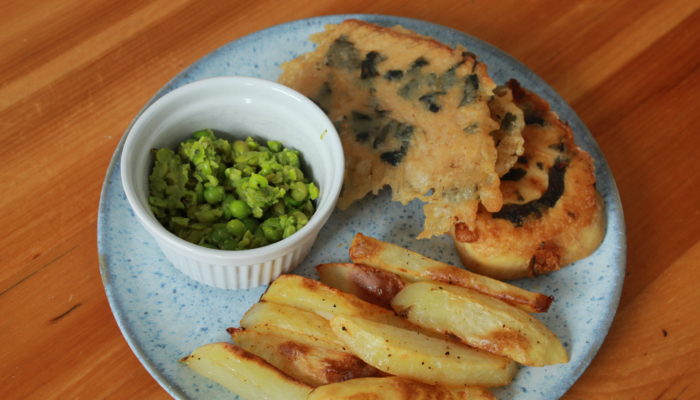 english tofish and chips with mushy peas on a plate