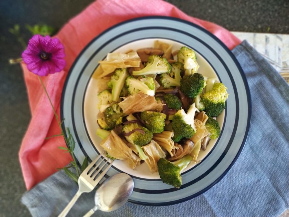 tofu stir fry on a plate with a fork and spoon
