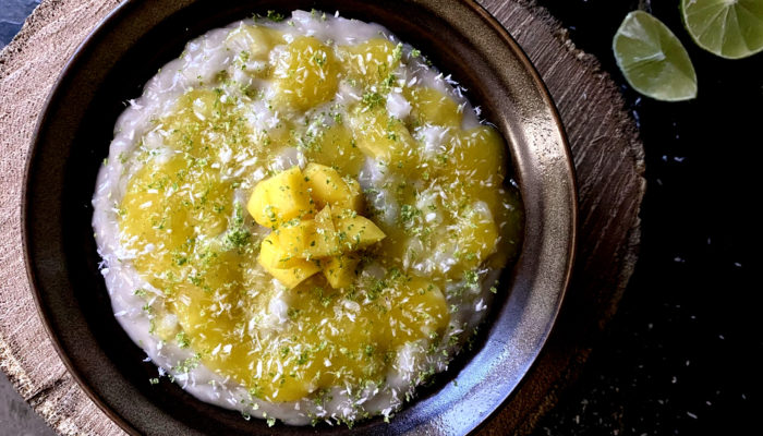 vegan mango lime rice pudding in a dark bowl