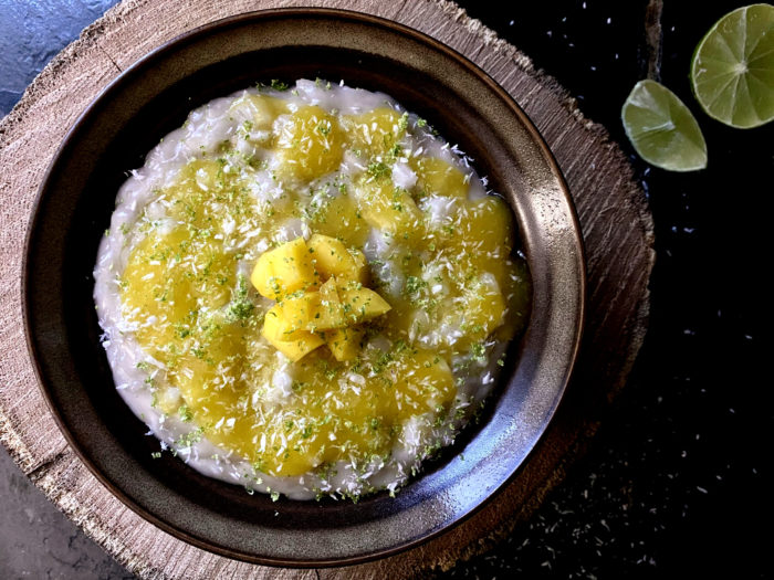 vegan mango lime rice pudding in a dark bowl