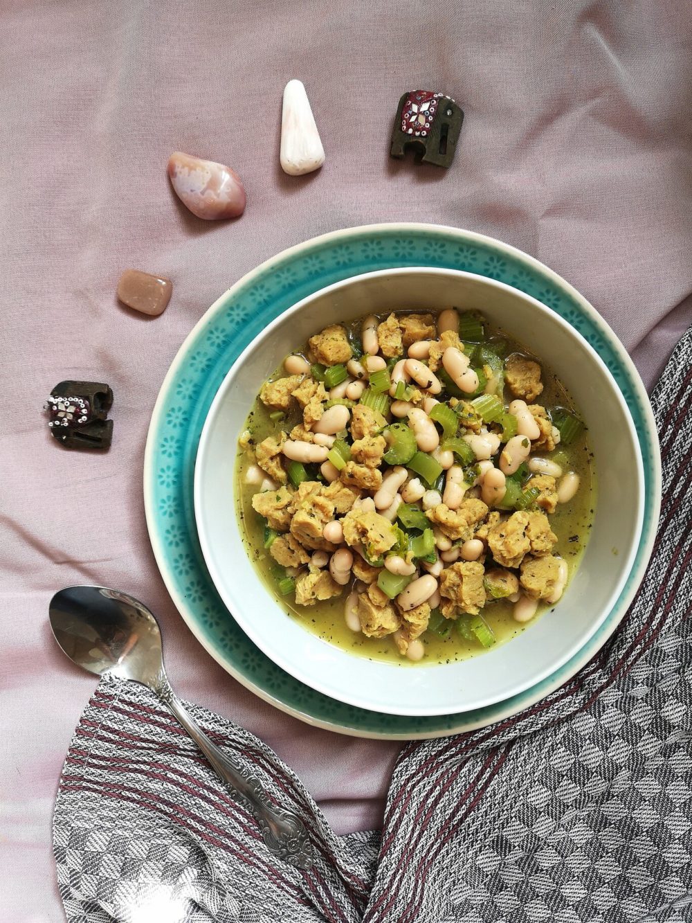 vegan persian celery stew in a bowl with a spoon and crystals
