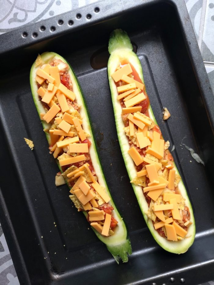 vegan nacho stuffed zucchini boats in a baking tray