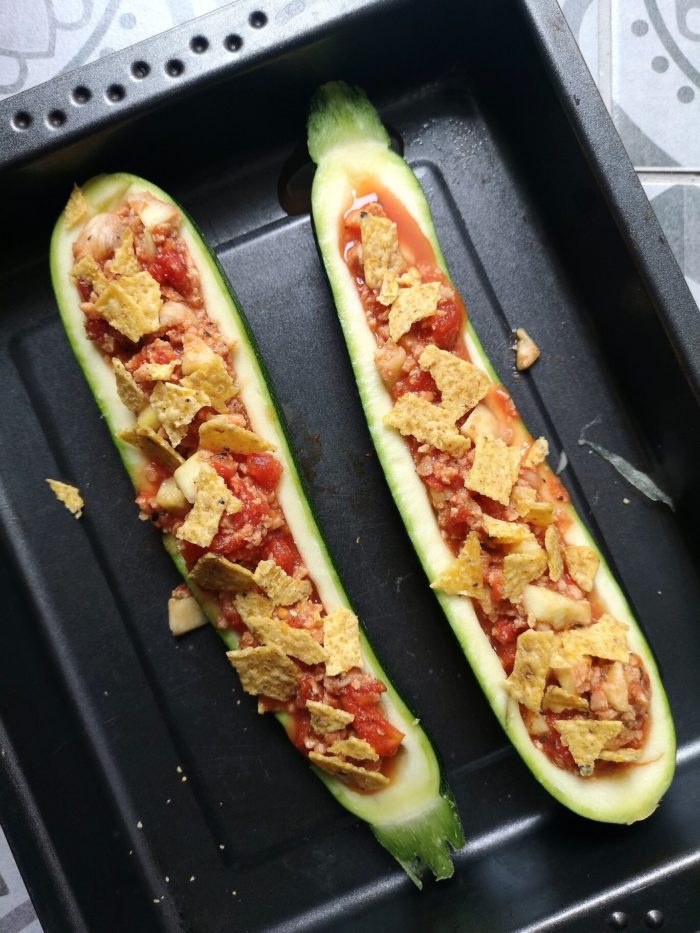 vegan nacho stuffed zucchini boat in a baking tray