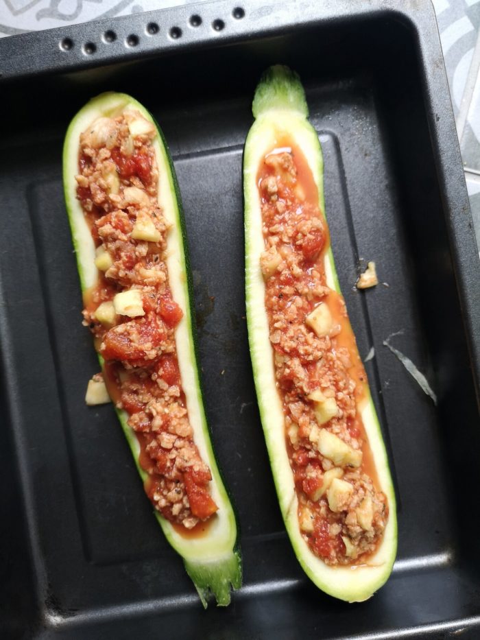 vegan nacho stuffed zucchini boat in a baking tray