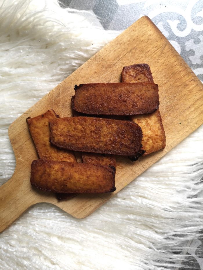 tofu bacon on a wooden cutting board