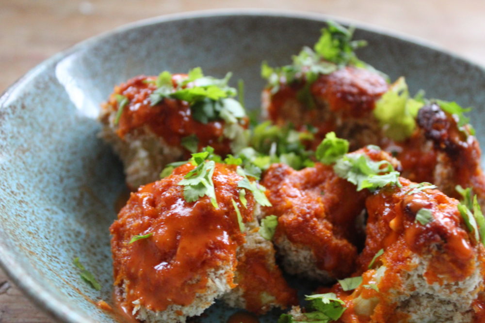 cauliflower wings on a plate on a table