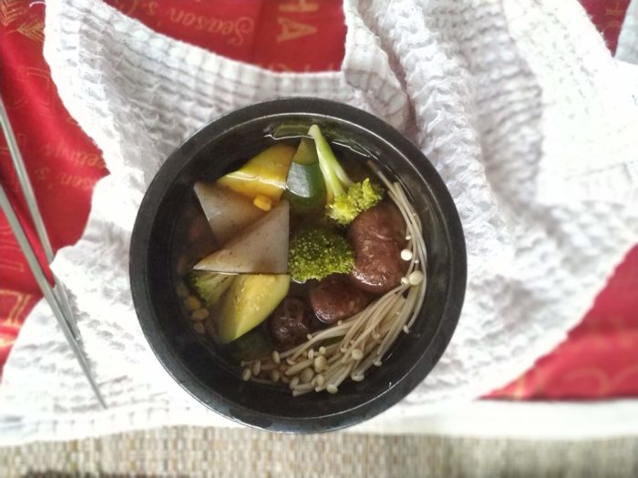 vegan oden stew in a black bowl