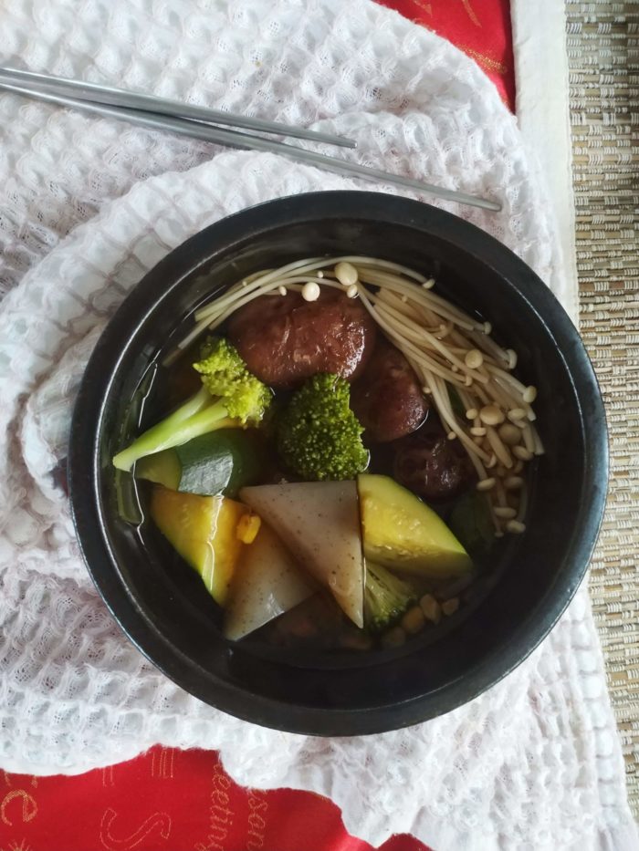 vegan oden stew in a black bowl