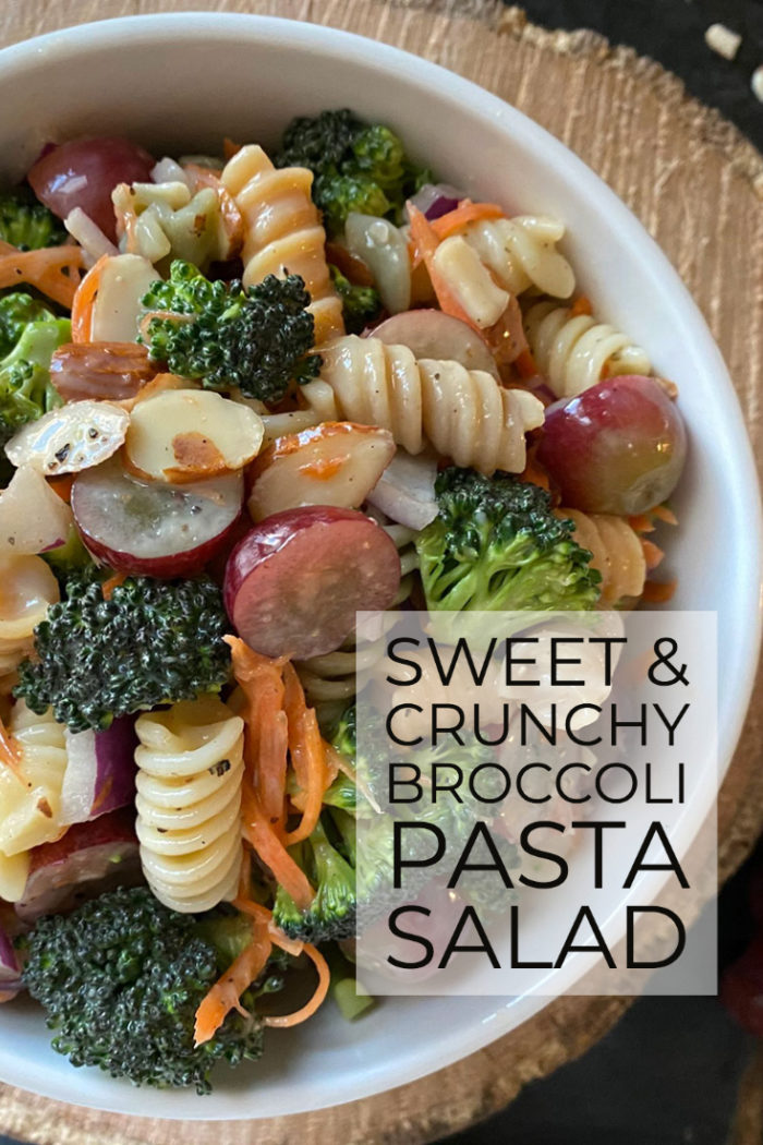 broccoli pasta salad in a white dish with a brown and black background with overlayed caption