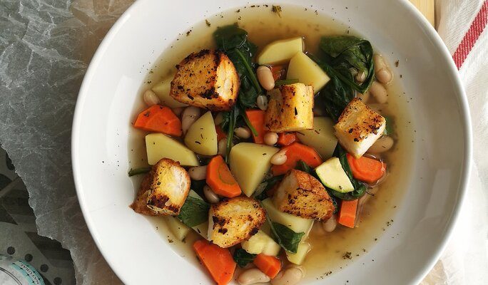 tuscan potato soup in a white bowl