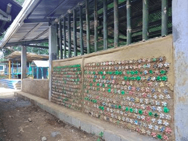 A building wall made out of bottle bricks