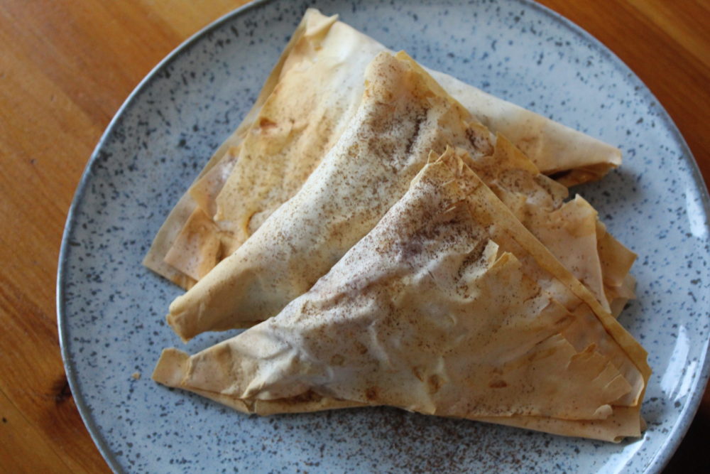vegan apple pie turnovers on a speckled plate