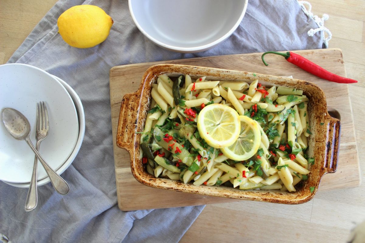 vegan zucchini and roasted lemon pasta in a dish on a cutting board