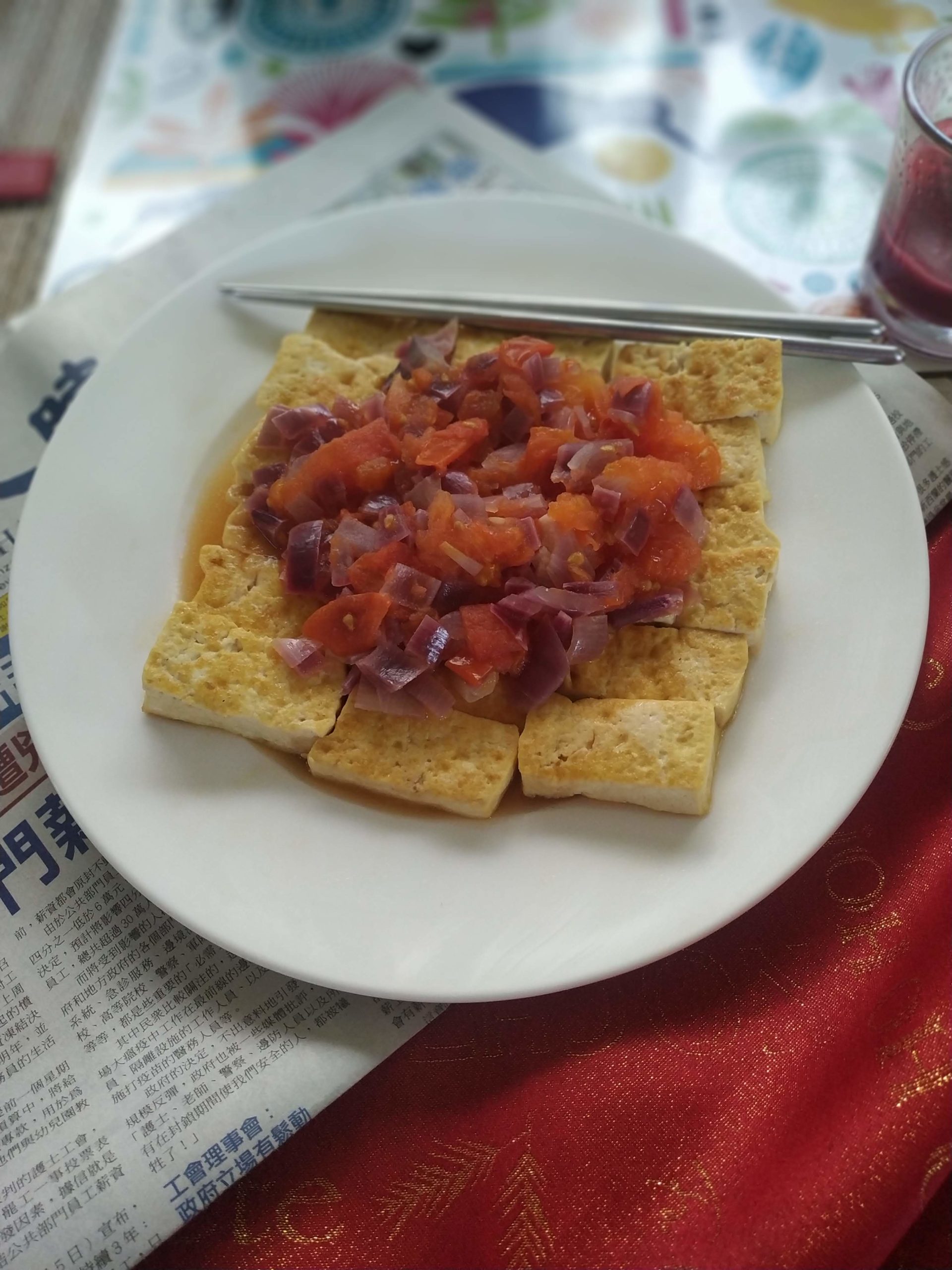 vegan tomato and tofu "egg" on a white plate